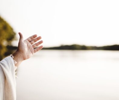 closeup-shot-person-wearing-biblical-robe-with-hand-up