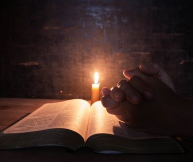 women-praying-bible-light-candles-selective-focus